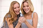 Two women reading message on a mobile phone