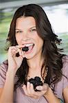 Portrait of a woman eating blackberries