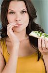 Portrait of a woman eating a bread