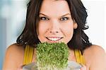 Woman holding a bunch of bean sprouts in a plate