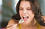 Close-up of a woman eating sushi