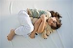 High angle view of a girl sleeping with a teddy bear