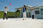 Three children playing with a ball