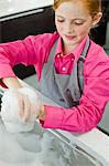 Close-up of a girl washing her hands at a sink