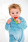 Portrait of a baby boy playing with a toy