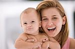 Woman holding her daughter and laughing