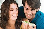 Couple eating bread and smiling