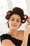 Close-up of a woman removing hair curlers