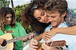Woman embracing a man playing ukulele