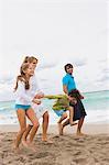 Family running on the beach