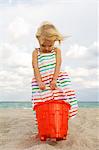 Girl holding a sand pail on the beach