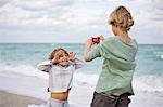 Boy taking his brother's picture with a digital camera