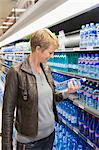 Woman buying water bottle in a store