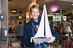 Woman holding a toy boat in a store