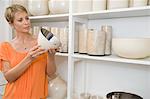 Woman holding a bowl in a store