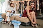 Two women trying on sandals in a boutique