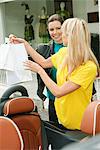 Two women smiling near a car after shopping