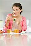 Woman having breakfast at a table