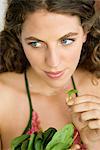 Woman holding spinach leaves in the kitchen