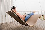 Man using a mobile phone on a porch swing