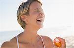 Woman holding a perfume bottle and smiling