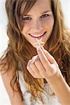 Woman showing a starfish and smiling