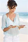 Woman looking at sticks on the beach