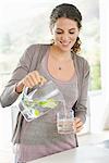 Close-up of a woman pouring lemonade