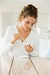 Woman mixing white clay for facial mask