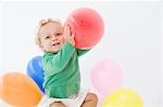 Baby boy playing with balloons