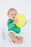 Baby boy holding a balloon