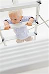 Baby boy climbing a step ladder