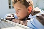 Boy resting on a deck chair