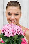 Woman holding a bouquet of roses and smiling