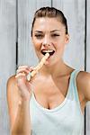 Portrait of a woman eating a breadstick