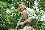 Boy playing in a garden and smiling