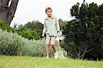 Boy playing with a butterfly net in a garden