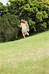 Girl playing with a butterfly net in a garden