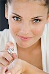 Woman applying perfume