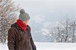 Young man in winter clothes looking back