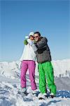 Young couple in ski wear taking self portrait