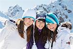 Three teenage girls in ski clothes, smiling at camera