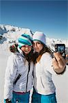 Two teenage girls in ski clothes, taking self portrait