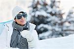 Young woman listening to MP3 player in snow