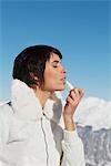 Young woman applying lip balm