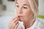 Woman taking a capsule