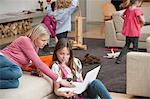 Woman assisting her daughter in using a laptop