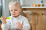 Boy eating with a fork and making a face