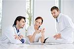 Three doctors examining medicine