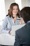 Businesswoman showing a credit card to a businessman